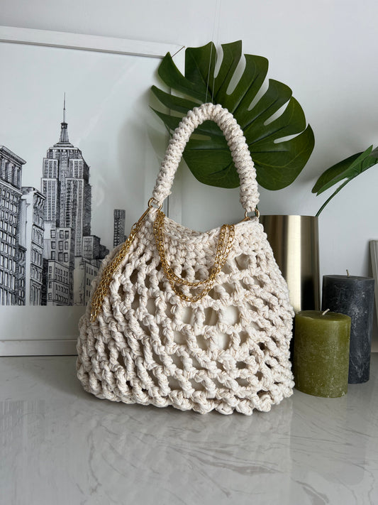 The Gold Threaded Mesh Handbag is handcrafted with our signature eco-friendly yarn with a gold thread detail. Designed for a luxurious look, it features a draw string inner security lining.