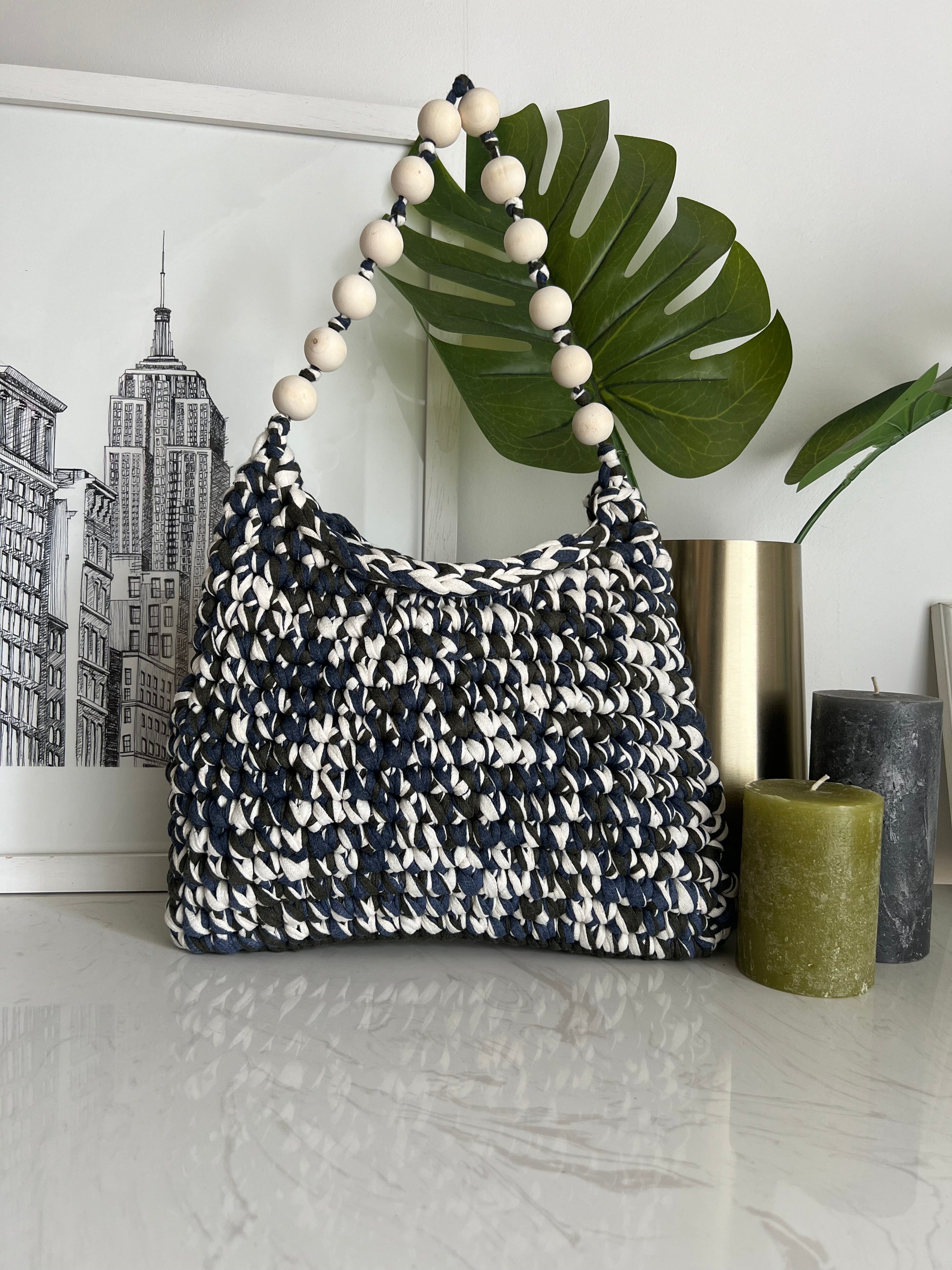 A combination of khaki, navy and cream, makes this handbag an essential item to your wardrobe. Raw wood beads to add a touch of elegance and unique style.