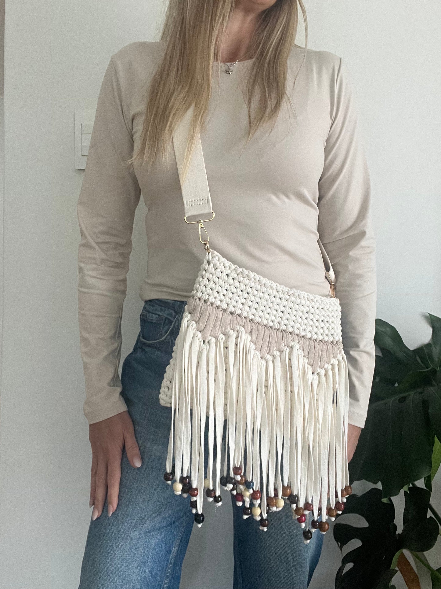 Cream and Beige Clutch with tassles and beads. This fun Crossbody Strap Bag keeps your essentials close while leaving your hands free to make a statement.