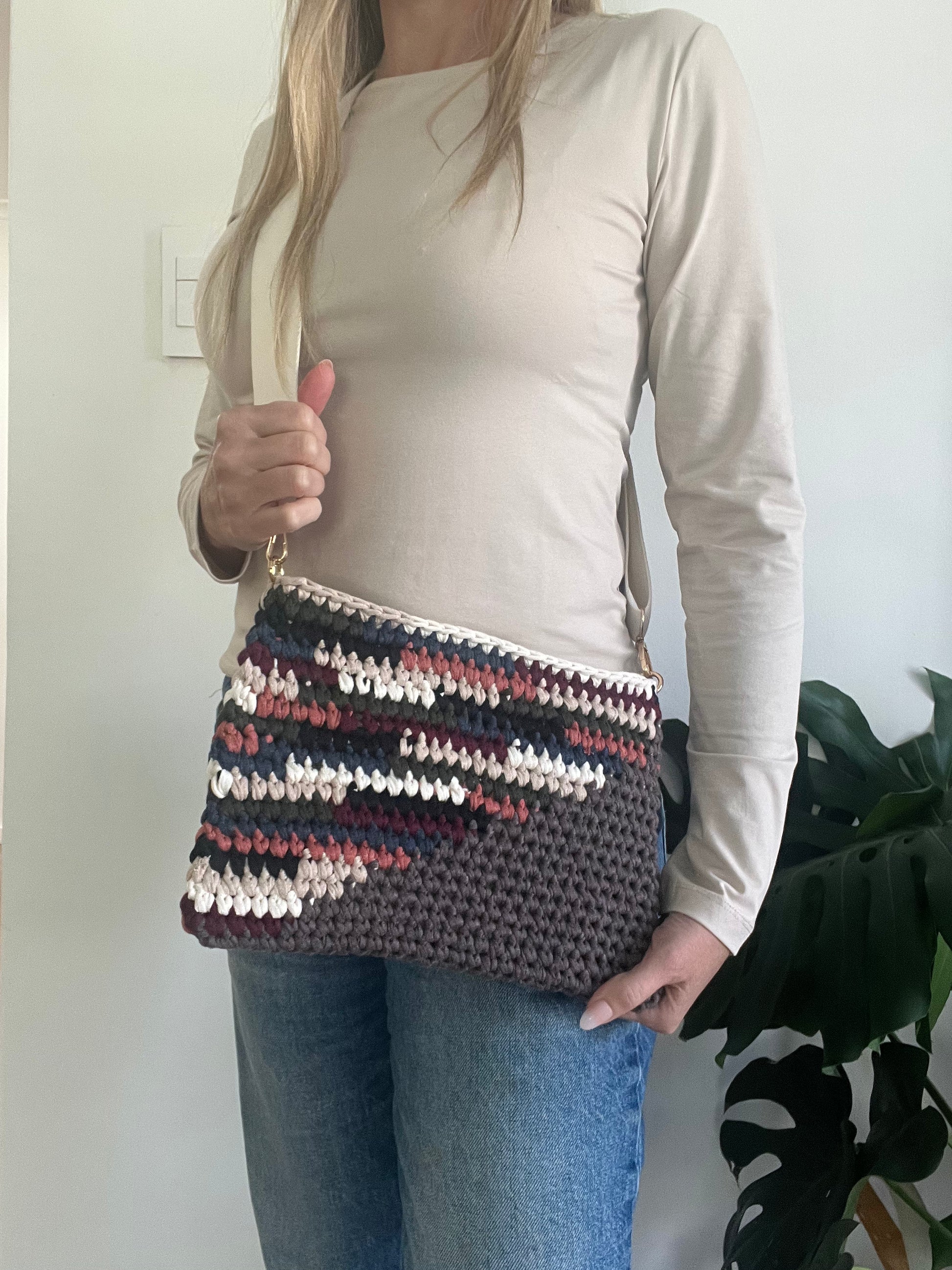 Brown and Multicoloured Stripes Clutch with attachable Crossbody Strap. Convenient for all your essentials while leaving your hands free for life’s adventures.