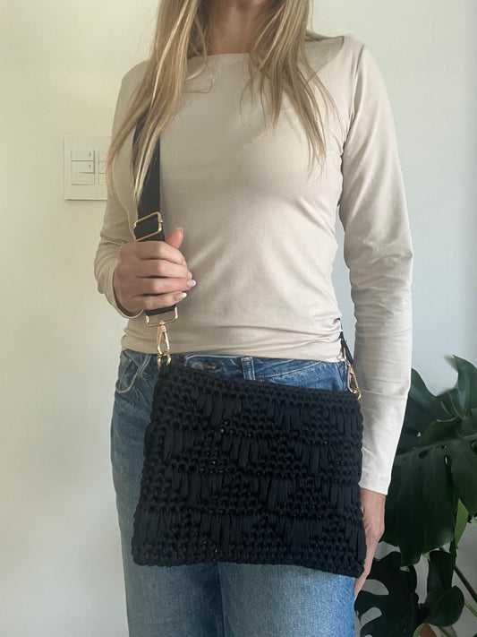 Textured black Clutch Bag with attachable crossbody strap Bag crocheted with eco-friendly yarns, this bag is as light on your shoulders as it is on the planet.