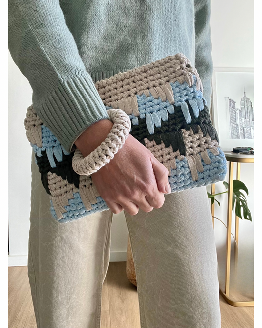 This modern clutch redefines style and functionality. With an attachable crochet bangle for a secure, hands-free hold that adds a playful yet practical twist.