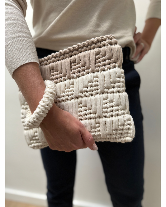 This modern clutch redefines style and functionality. Built-in crochet bangle for a secure, hands-free hold that adds a playful yet practical twist.