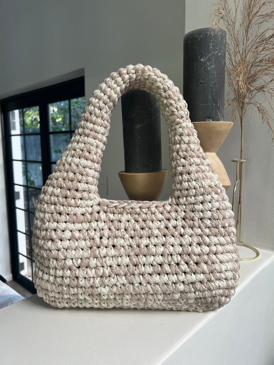 Elevate your daily look with this beautiful handcrafted handbag. Make it a functional staple, while its neutral tone adds effortless elegance to any outfit.
