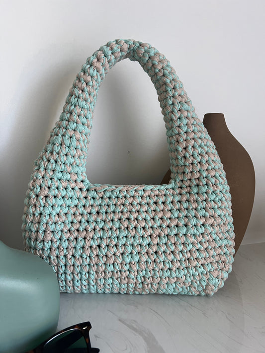 Lovingly crocheted from high-quality recycled yarns, it’s a sustainable choice that doesn’t compromise on style and adds effortless elegance to any outfit.